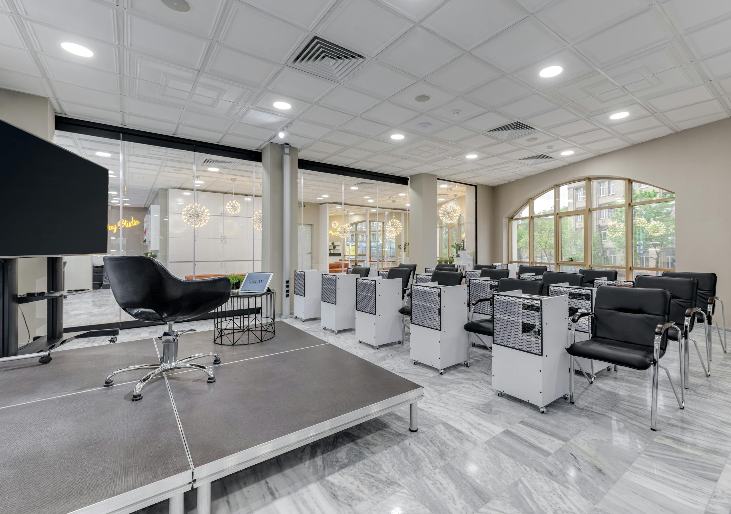 Spacious conference room with podium, chairs, and glass partitions featuring modern design elements.
